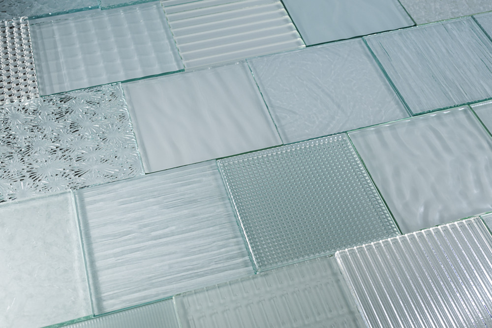 mutliple-glass-panels-with-patterns-laying-next-to-each-other-on-ground